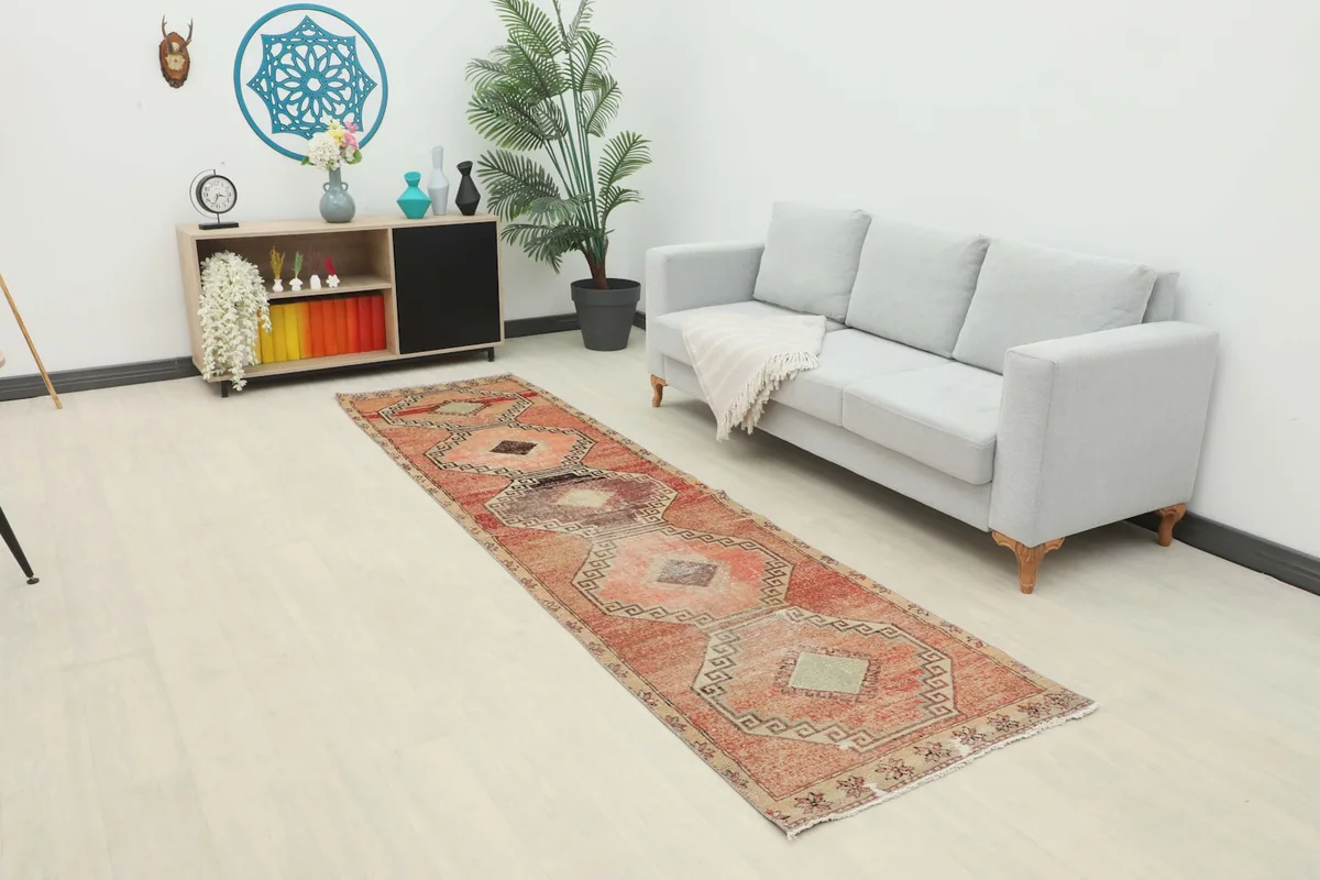 Runner rug displayed in a bright living space with a sofa and shelving