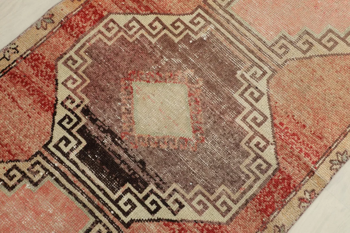 Detailed view of a central medallion with varied brown and beige shading