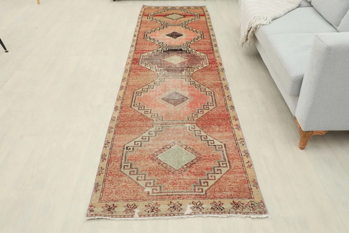 Overhead view of the runner rug laid out in a room, showing its full design