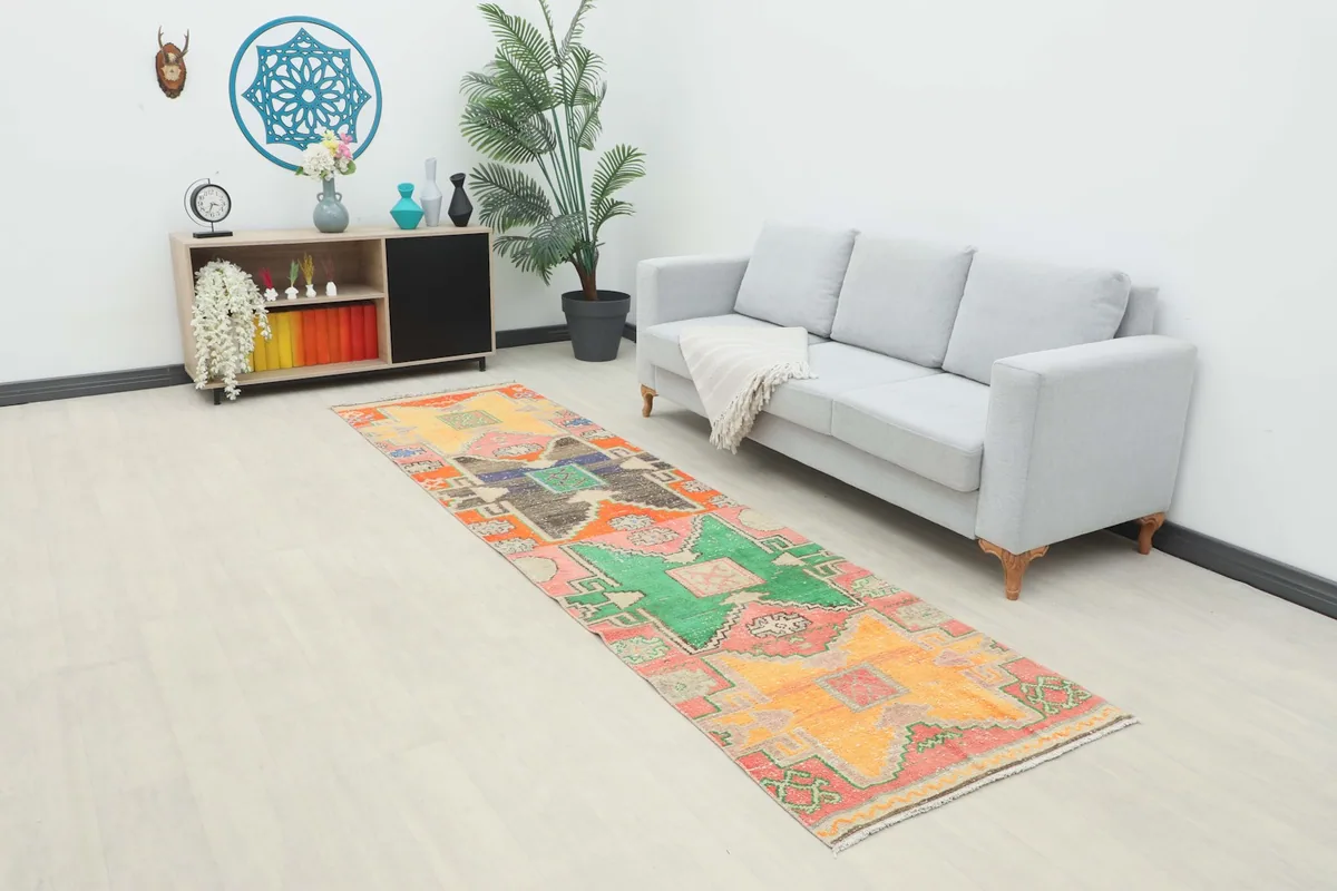 Long view of the multicolor runner rug in a modern living space with a sofa