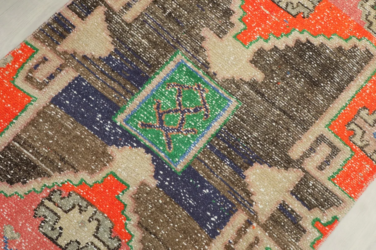 Detailed view of a central motif with black, brown, blue, and green colors