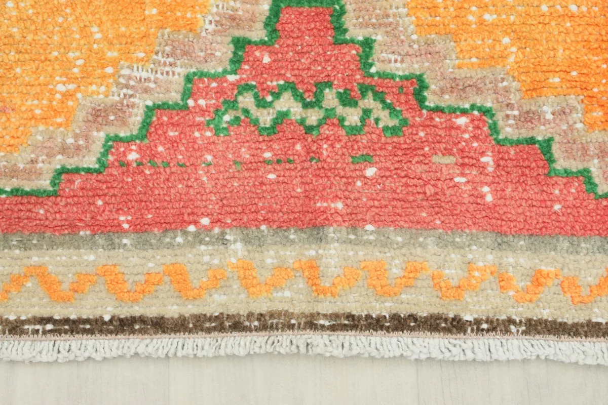 Close-up of the runner's end showing fringe and a colorful stepped border design