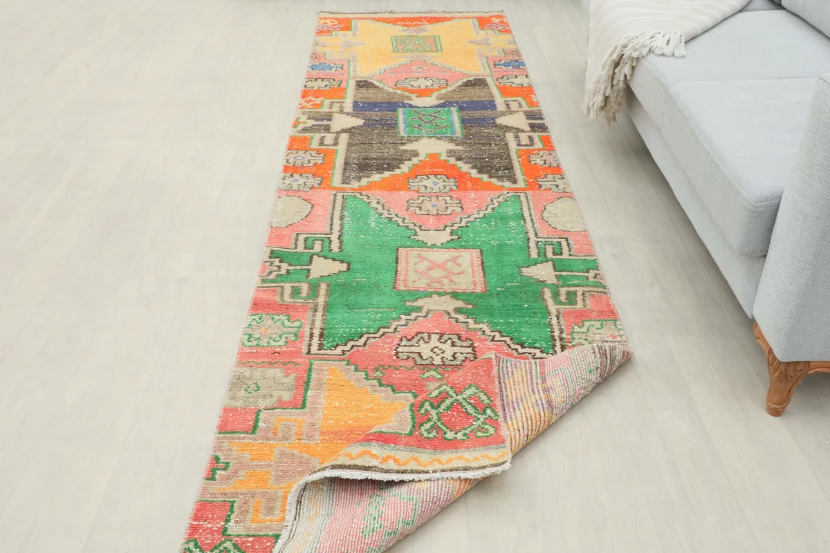View of the runner rug partially folded, showing the back and pile texture