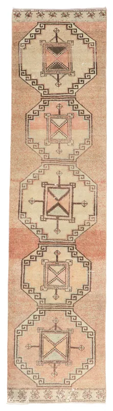 Full overhead view of the beige and rust Anatolian runner with geometric tribal patterns on a white background