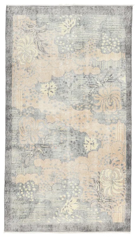 Full overhead view of the beige and gray vintage Anatolian rug with abstract floral patterns.