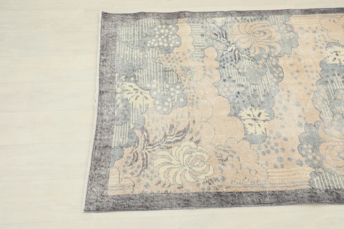 View from another angle, showcasing the rug's full length and its distressed finish.