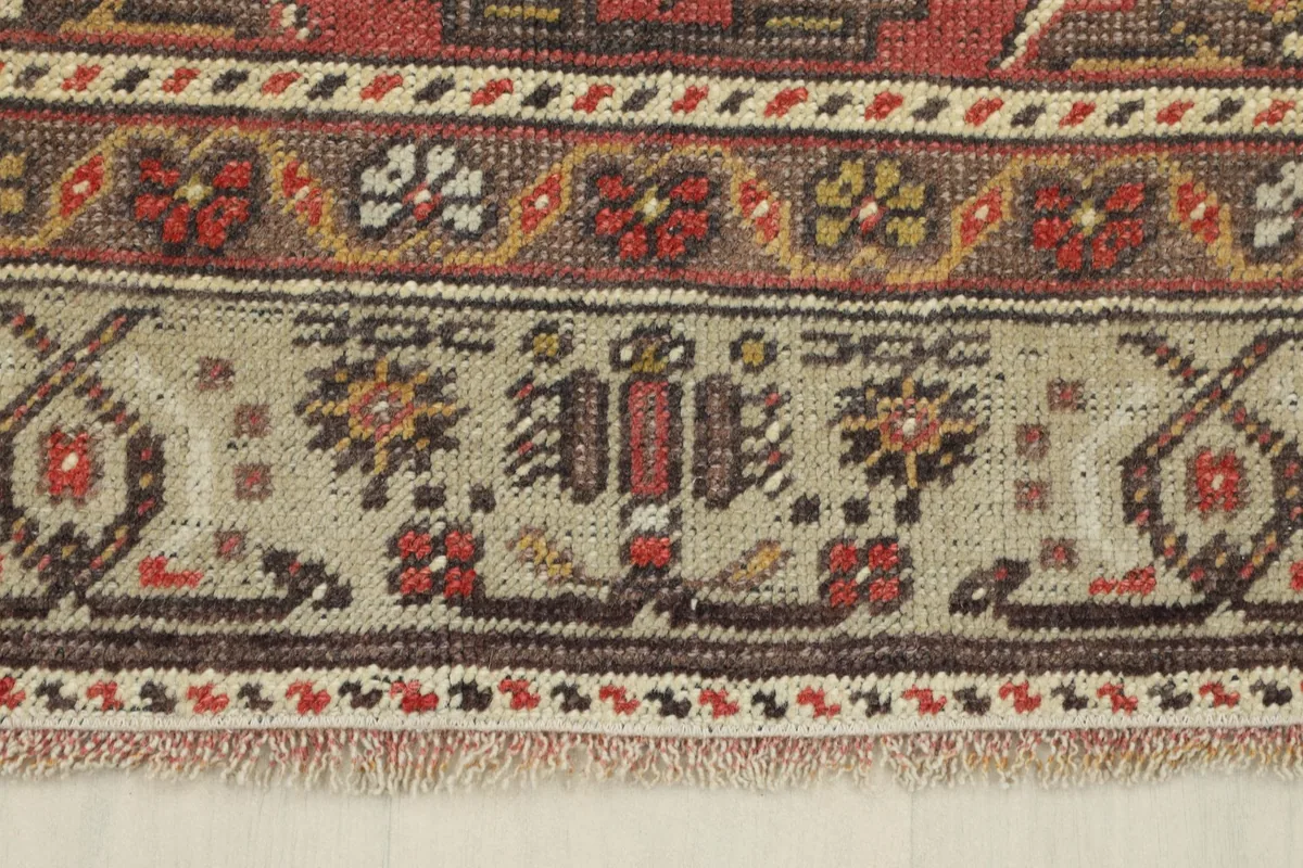 Close-up of the rug's border, displaying the detailed patterns, fringe, and the professionally cleaned wool pile.