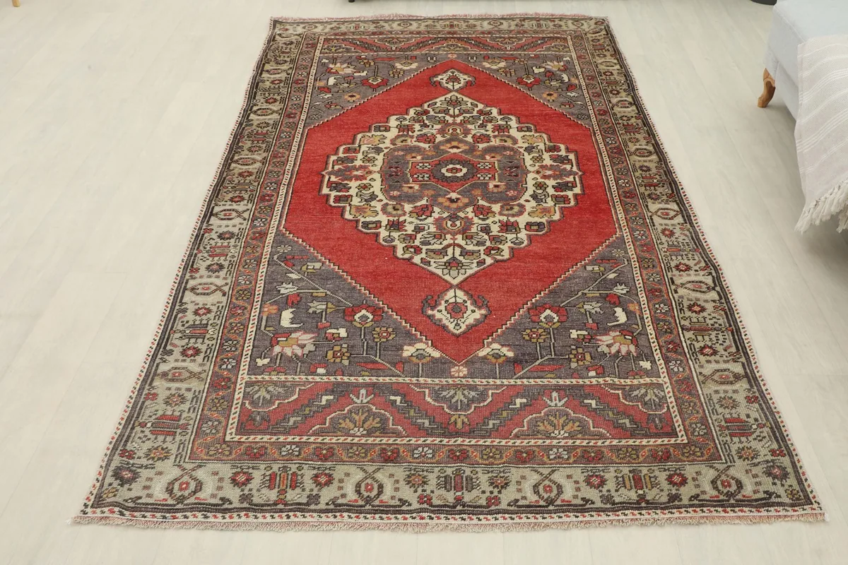 Full overhead shot of the vintage Anatolian rug laid out, showing its overall shape and design.