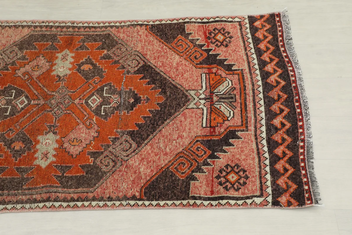 Close-up of the Rose Orange Geometric Anatolian Runner's end, showing border and geometric motifs.