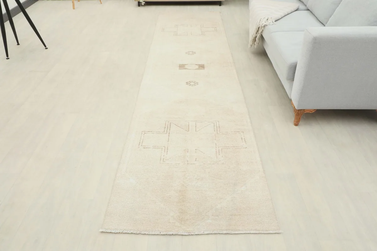 Full room view of the beige and tan runner rug laid out in a contemporary setting