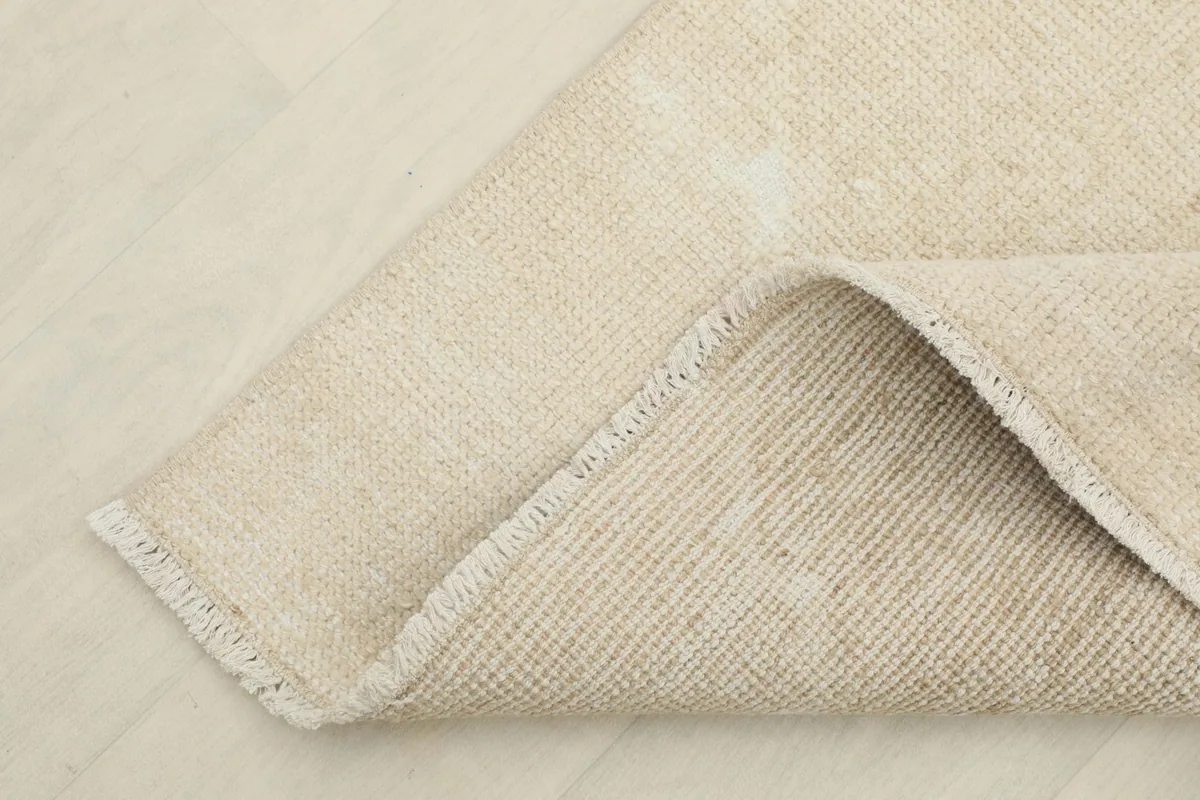 View of the back of the hand-knotted rug, showing the cotton foundation