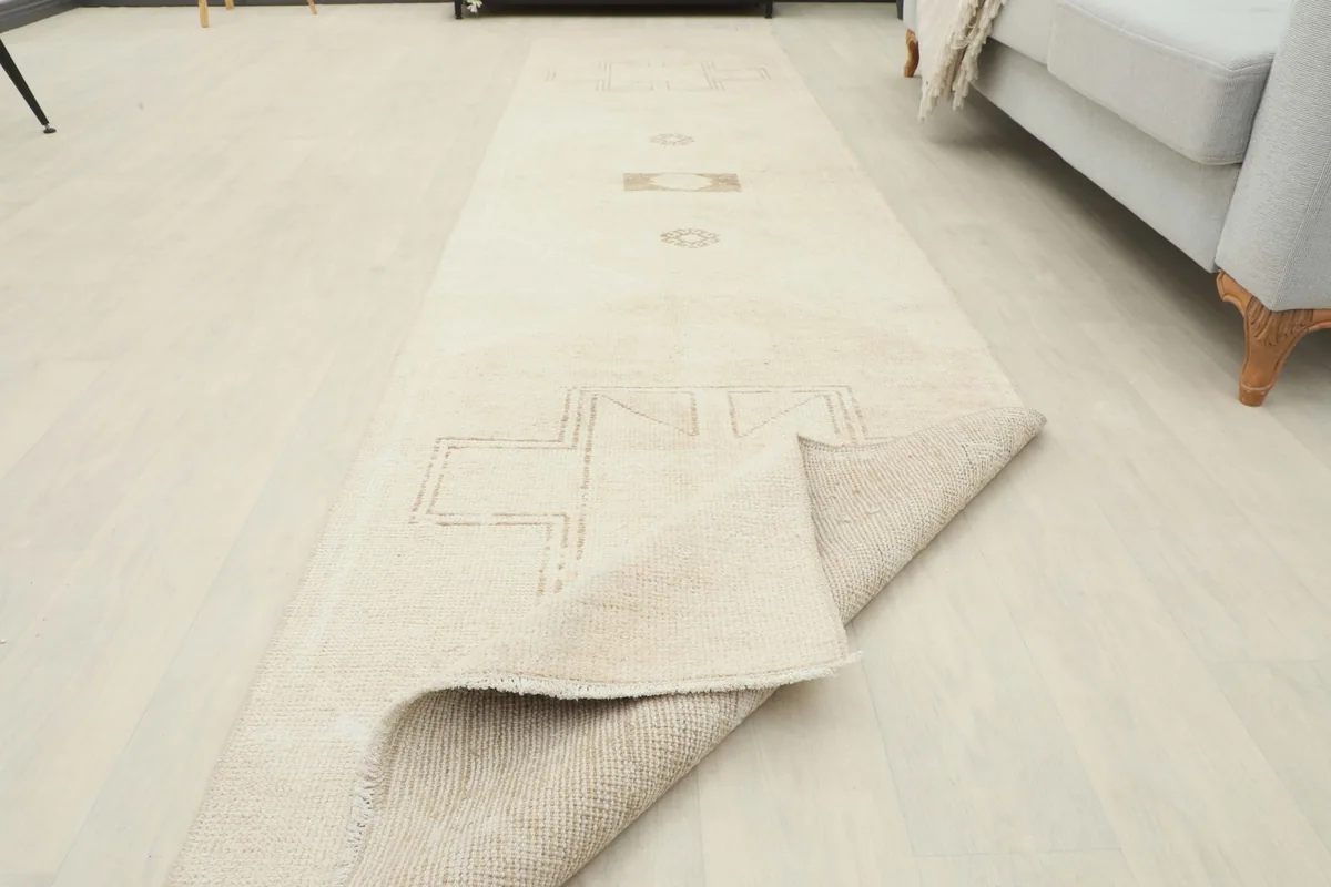 Corner of the runner rug folded to reveal the thickness and construction
