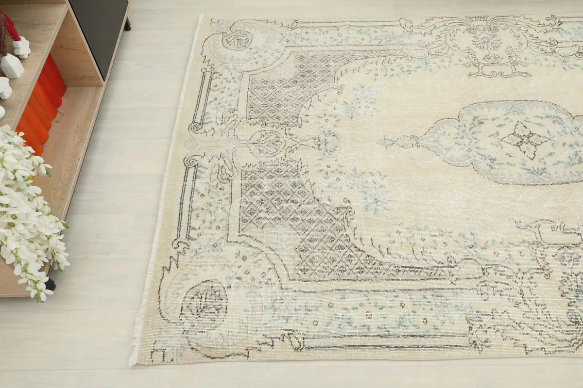 View of one corner of the rug, highlighting the intricate blue and gray patterns and border