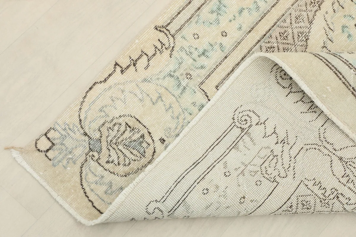 Detail of the rug's back, showing the consistent hand-knotting and cotton foundation