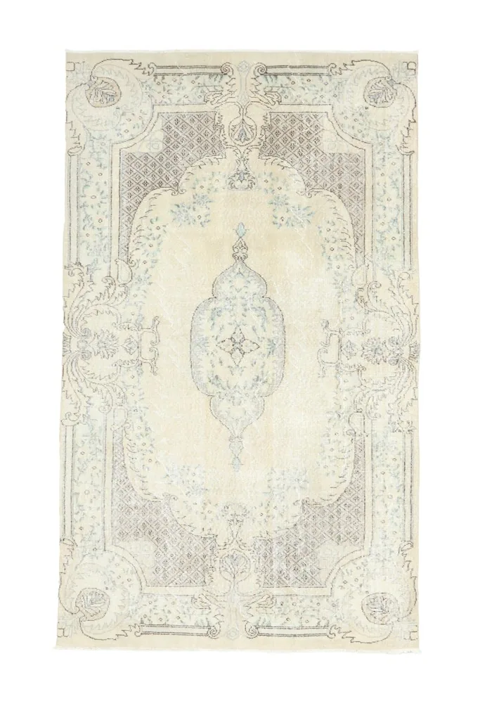 Full overhead view of the ivory and blue vintage Anatolian rug on a white background