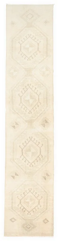Full overhead view of the ivory and beige geometric vintage runner rug on a white background.