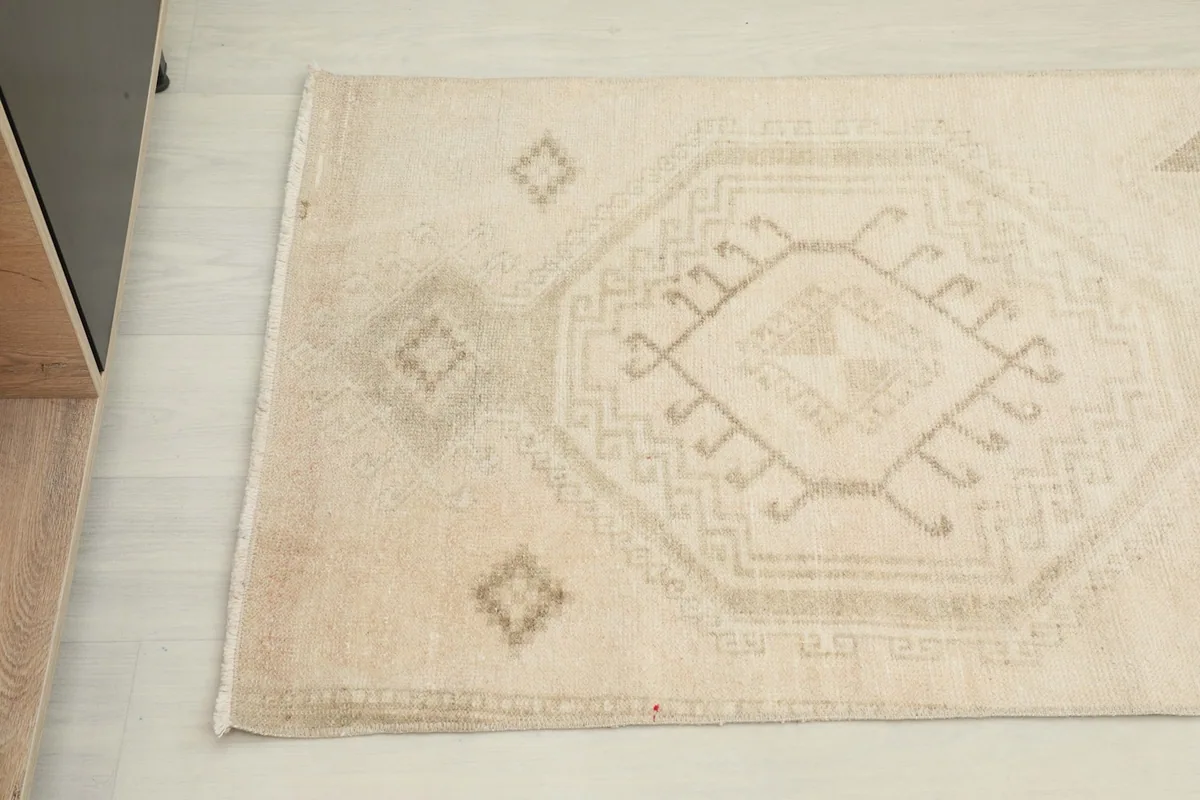 Close-up angled view of a section of the runner rug, highlighting the distinct geometric motifs.