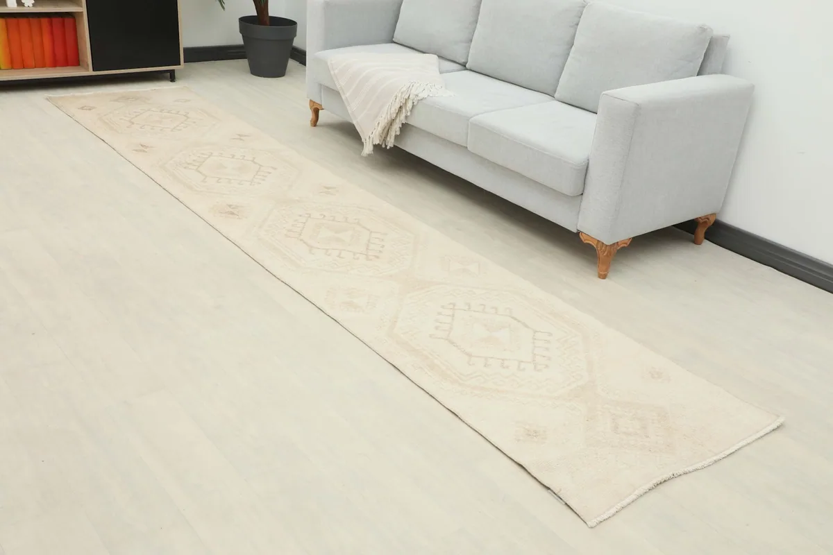 Overhead view of the runner rug extending from a light gray sofa in a contemporary room.