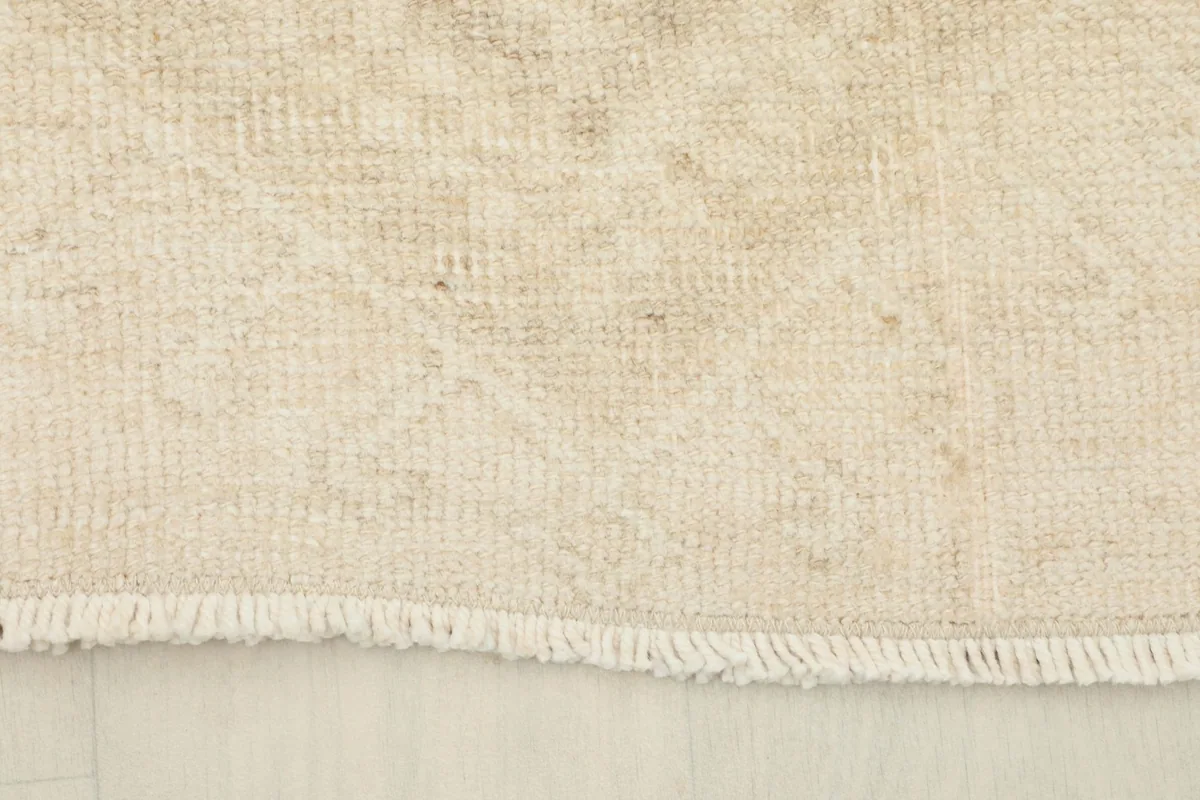 Close-up of the short, natural fringe and the edge of the professionally cleaned vintage runner.