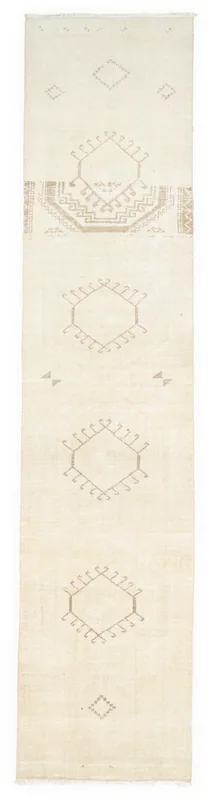 Full top view of a cream and tan geometric tribal runner rug