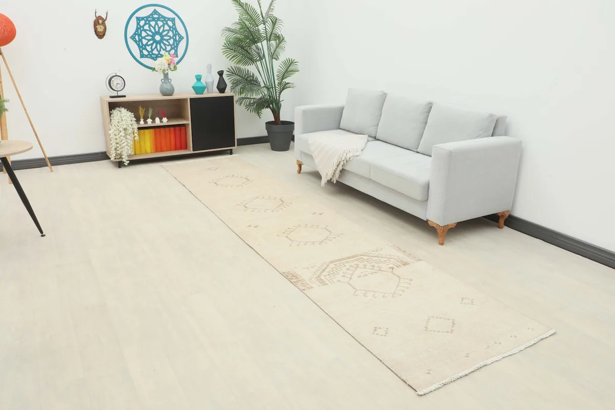 Cream and tan runner rug laid out in a living room setting