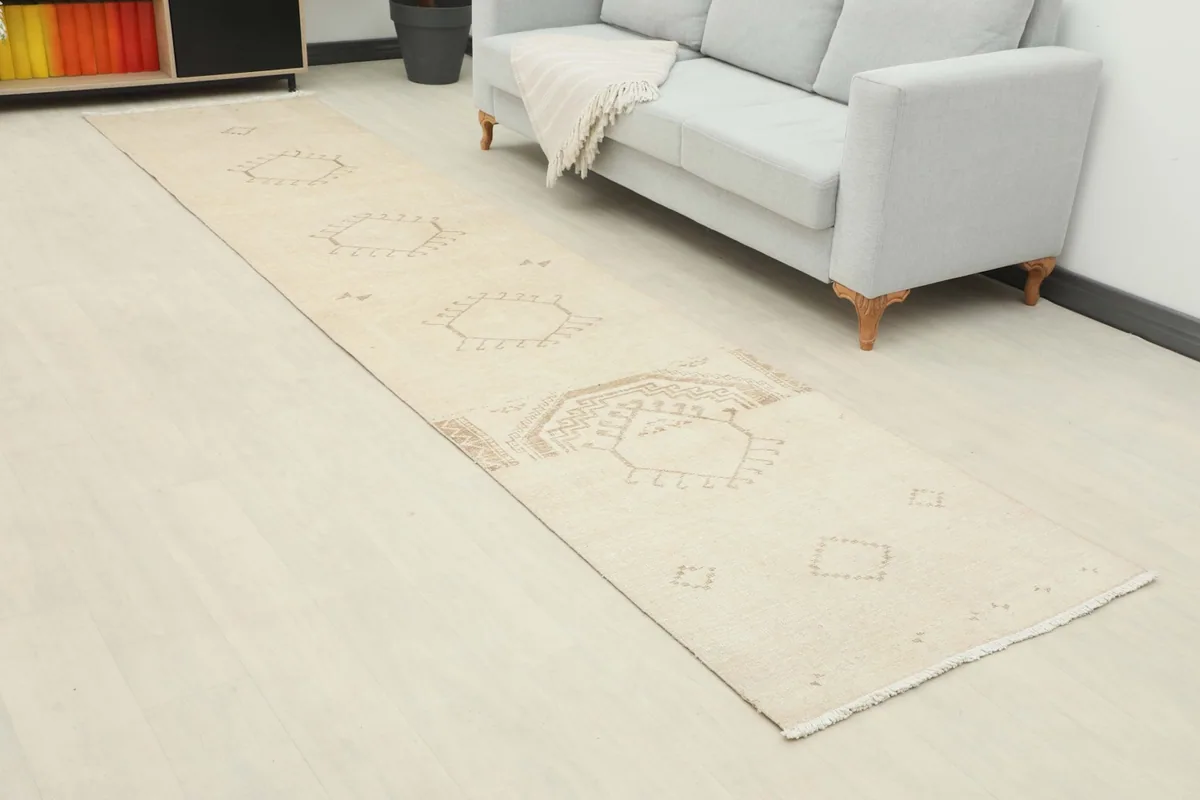 Overhead view of the cream and tan runner rug in a room with a sofa