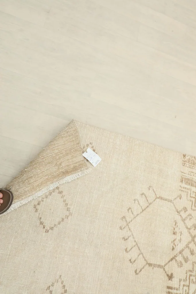Underside of the hand-knotted rug showing the cotton foundation