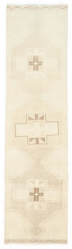 Full top view of the 2'7" x 10'4" ivory beige geometric runner rug on a white background.