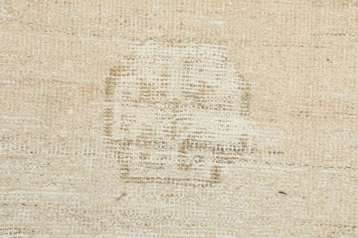 View of the back of the rug, showing the hand-knotted cotton foundation and wool knots
