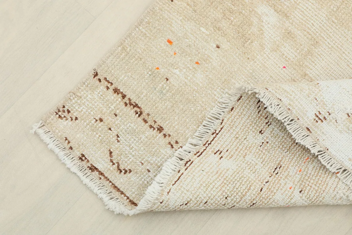 Corner of the runner folded back, revealing the pile and underside construction