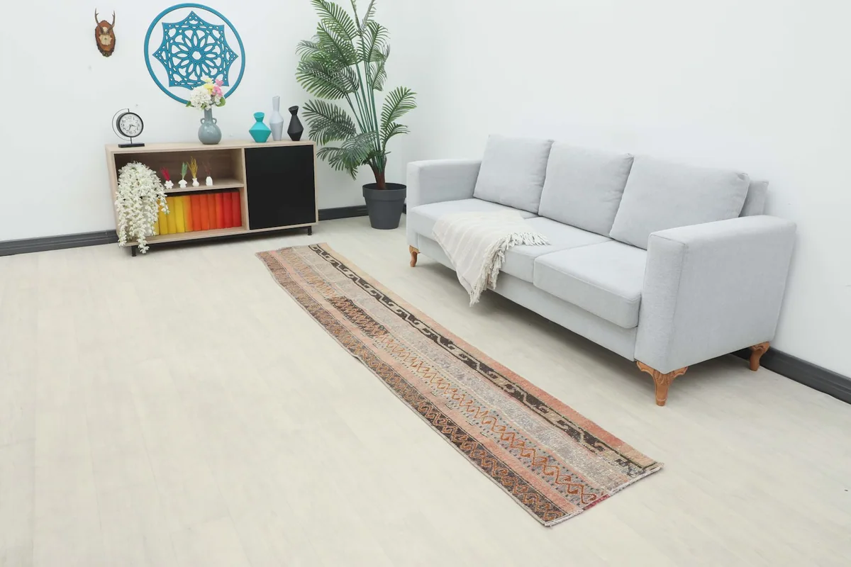 Long view of the runner in a modern living space, extending from a sofa