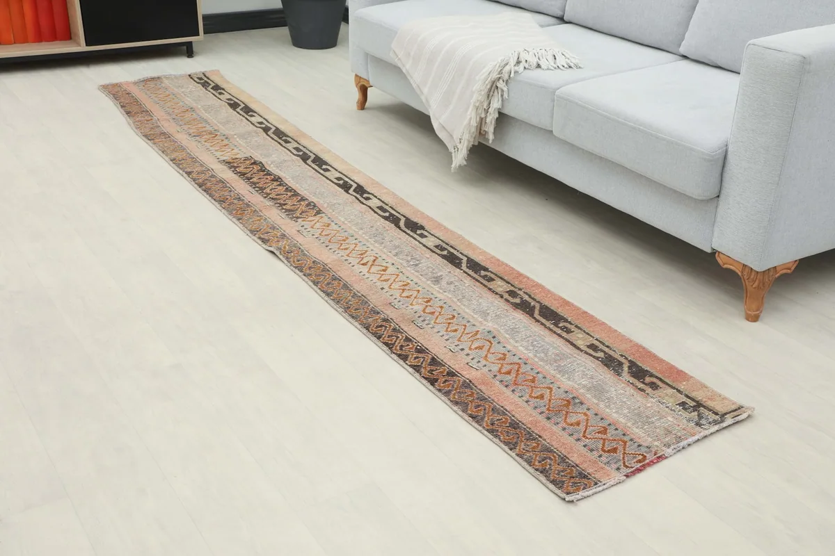 Angled view of the runner in a room, highlighting its length and striped design