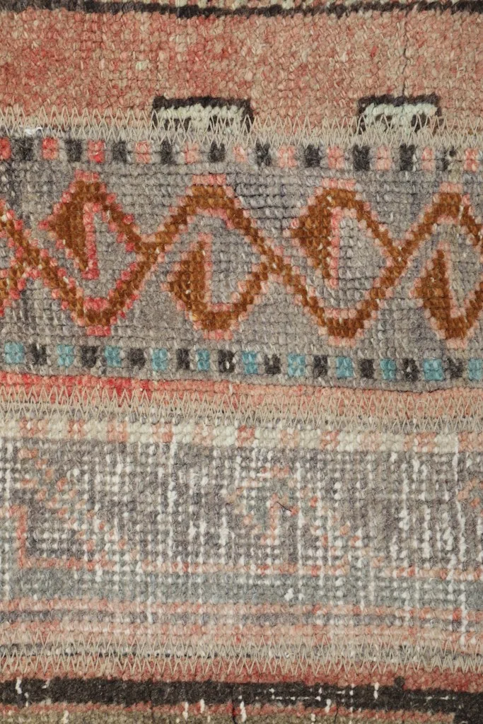Detailed view of the wool pile, revealing the hand-knotted texture and intricate motifs