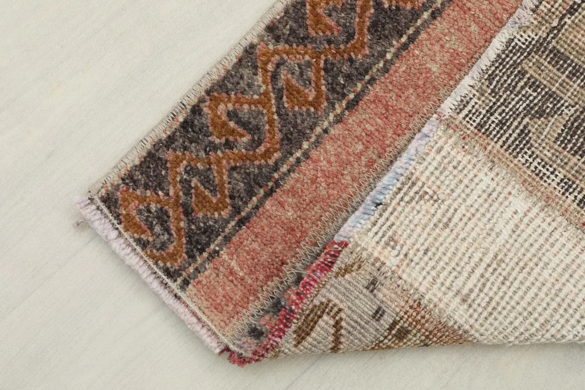 Close-up of the rug's reverse side, illustrating the cotton foundation and knotting