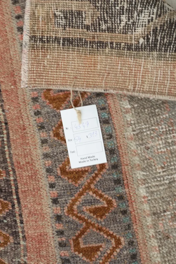 Detail of the rug tag, indicating hand-made and origin from Turkey