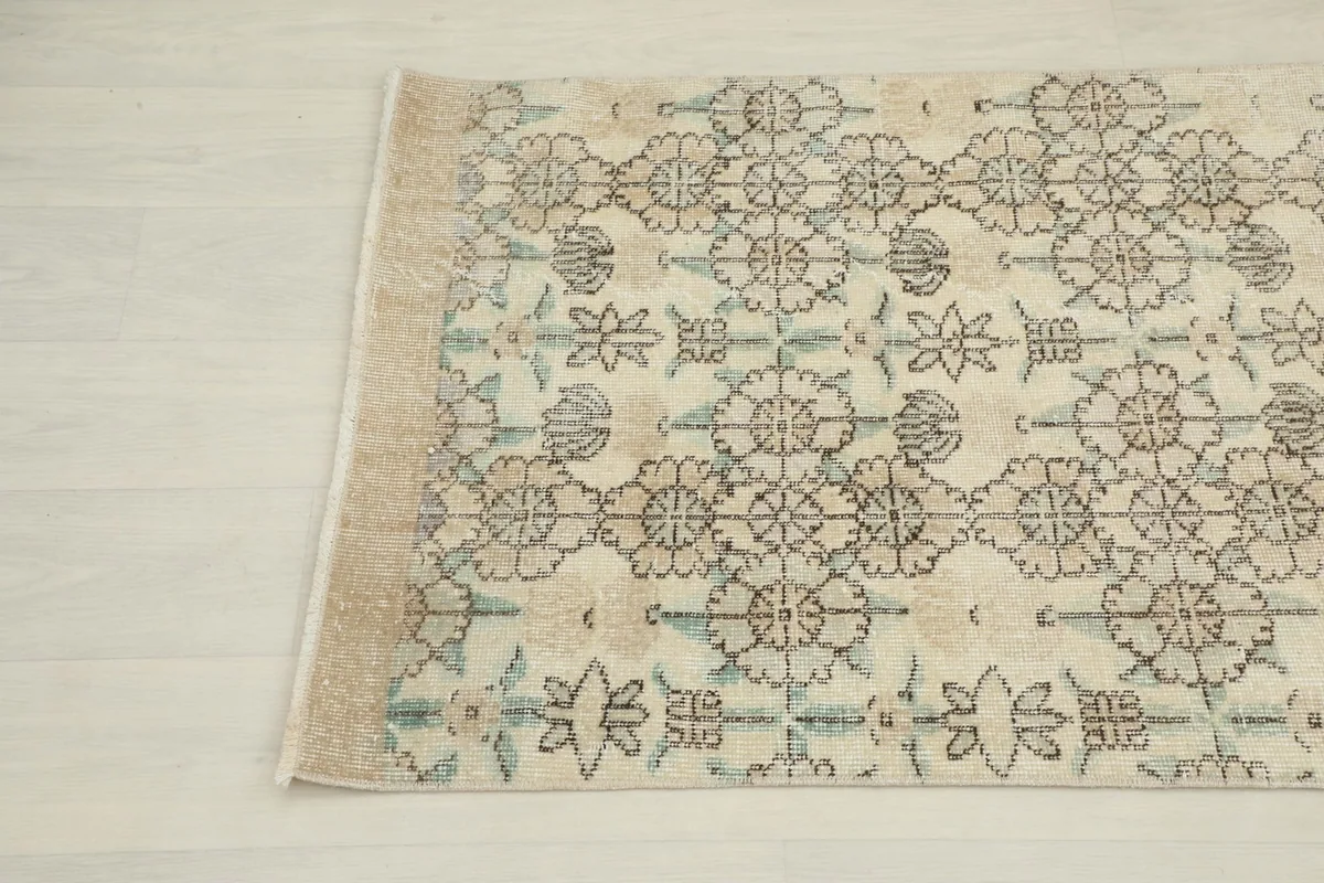 Another close-up angle of the rug showing the repeating geometric pattern and subtle color variations.