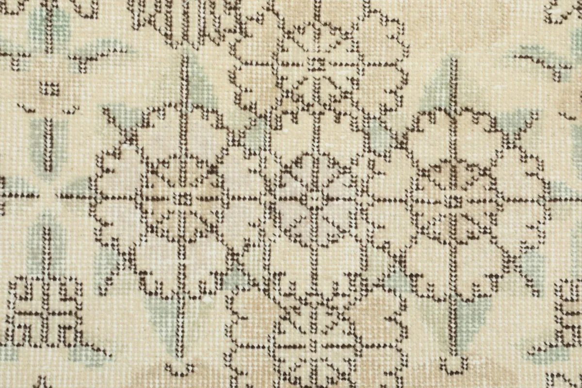 Macro detail of the rug's surface, highlighting the intricate knotting and color blend of the pattern.