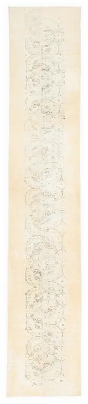 Full overhead view of the beige vintage runner rug with faded medallion patterns on a white background.