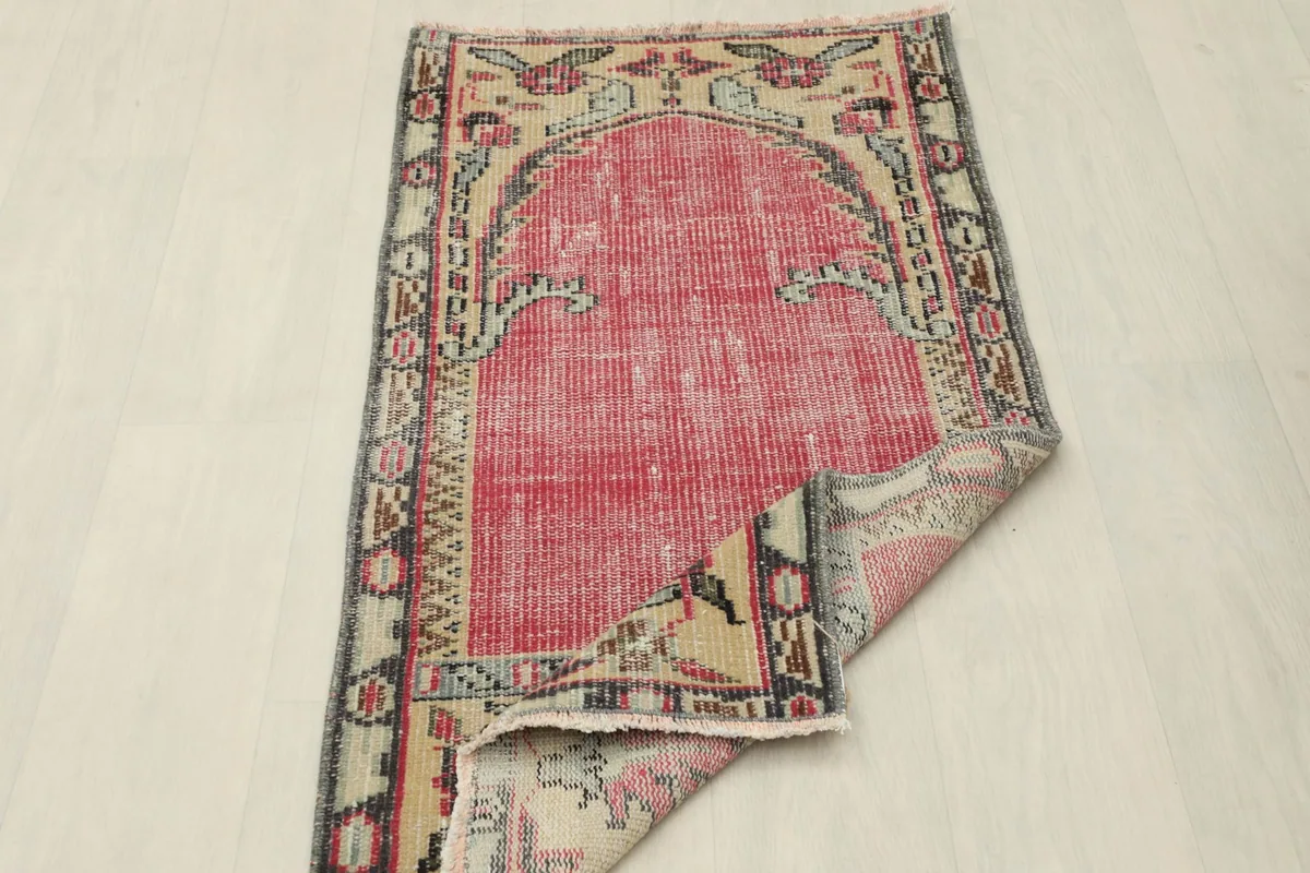 Rug partially folded, displaying both the top surface and the underside weaving