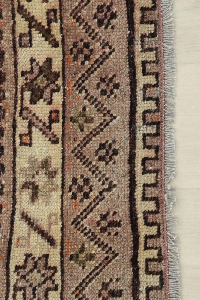Close-up of the patterned border and fringe of the vintage runner