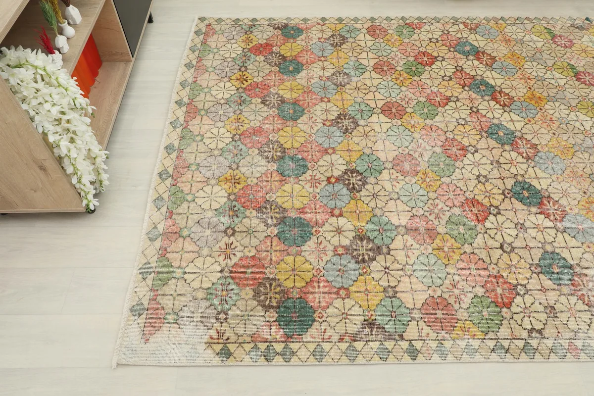 Overhead angle shot of the vintage rug, capturing its full pattern and colors from a higher perspective.