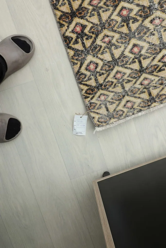 Overhead view showing a foot next to the rug, indicating scale and texture