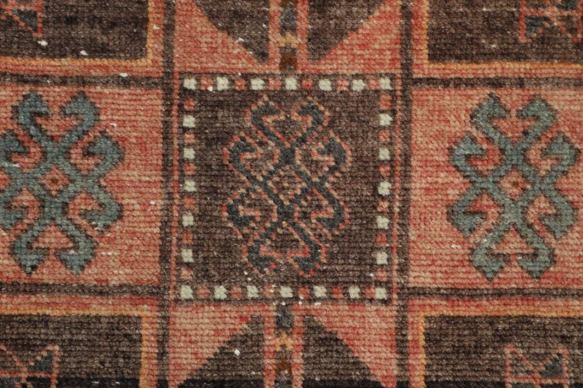 Extreme close-up of a specific tribal motif, showing the intricate hand-knotted details and individual knots