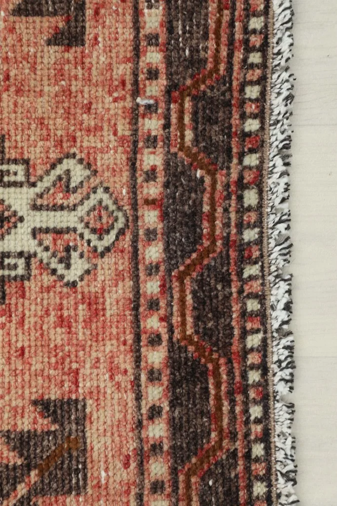 Close-up view of the rug's side border and edge, showing the pile and weave