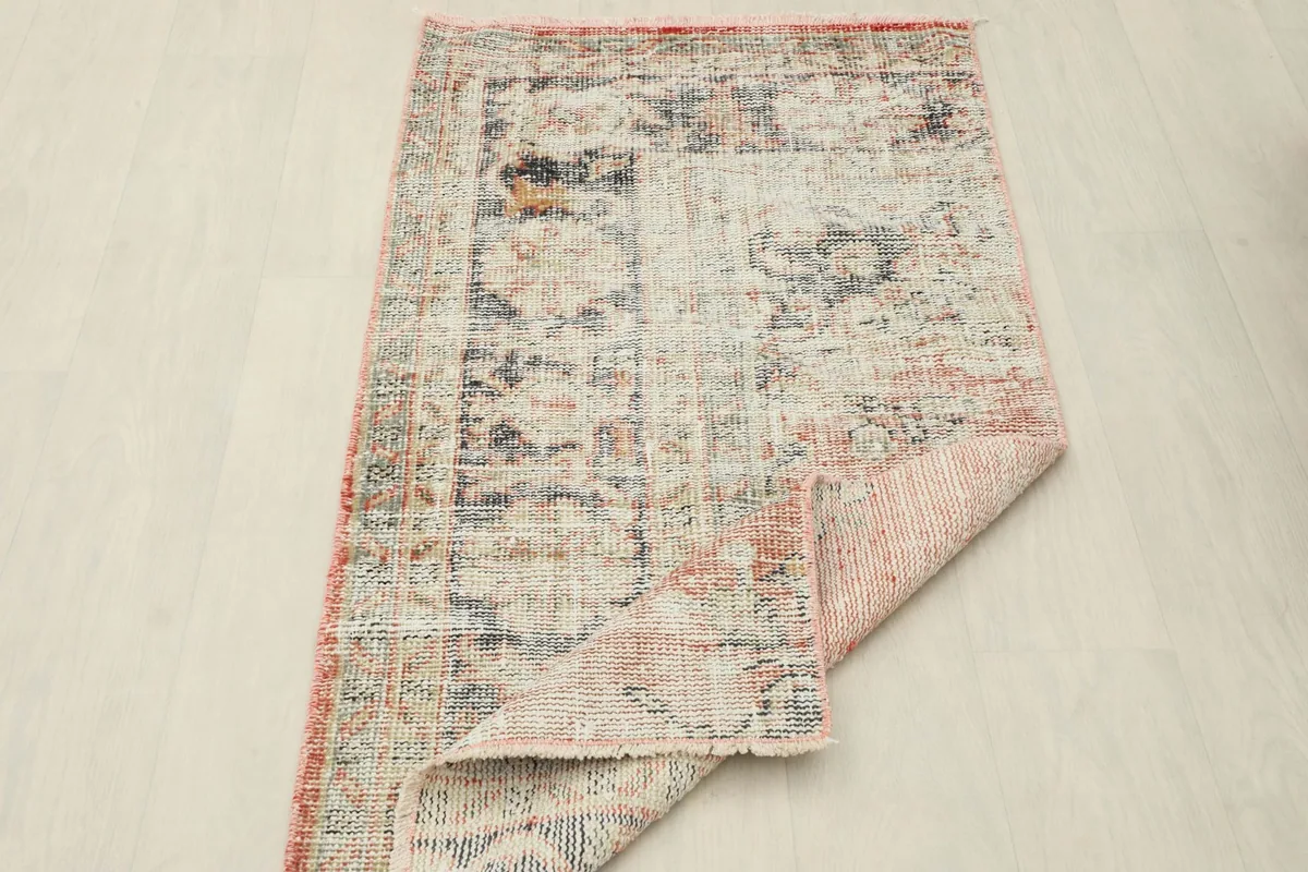 View of the rug's underside, revealing the intricate hand-knotted cotton foundation