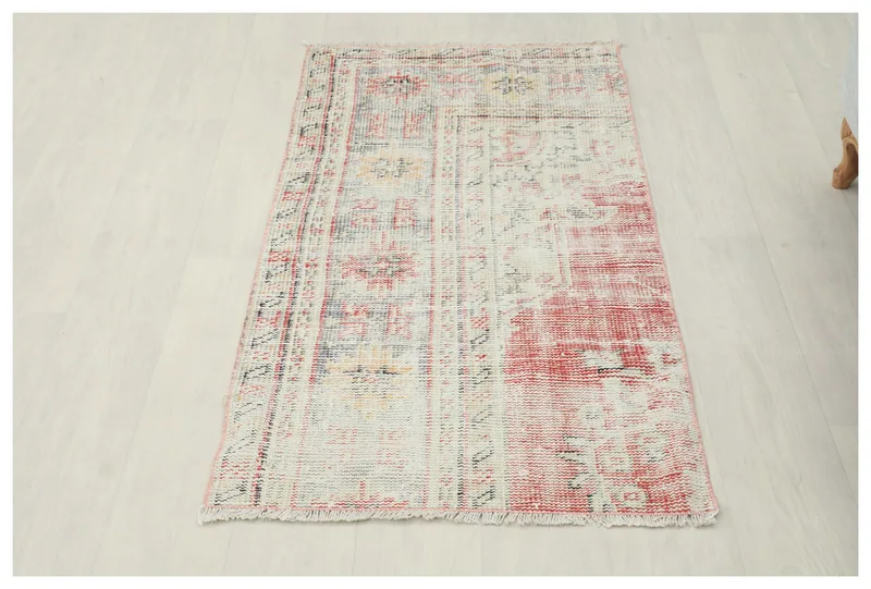 Full top view of the 2'3" x 4'3" cream and red geometric area rug on a white background.