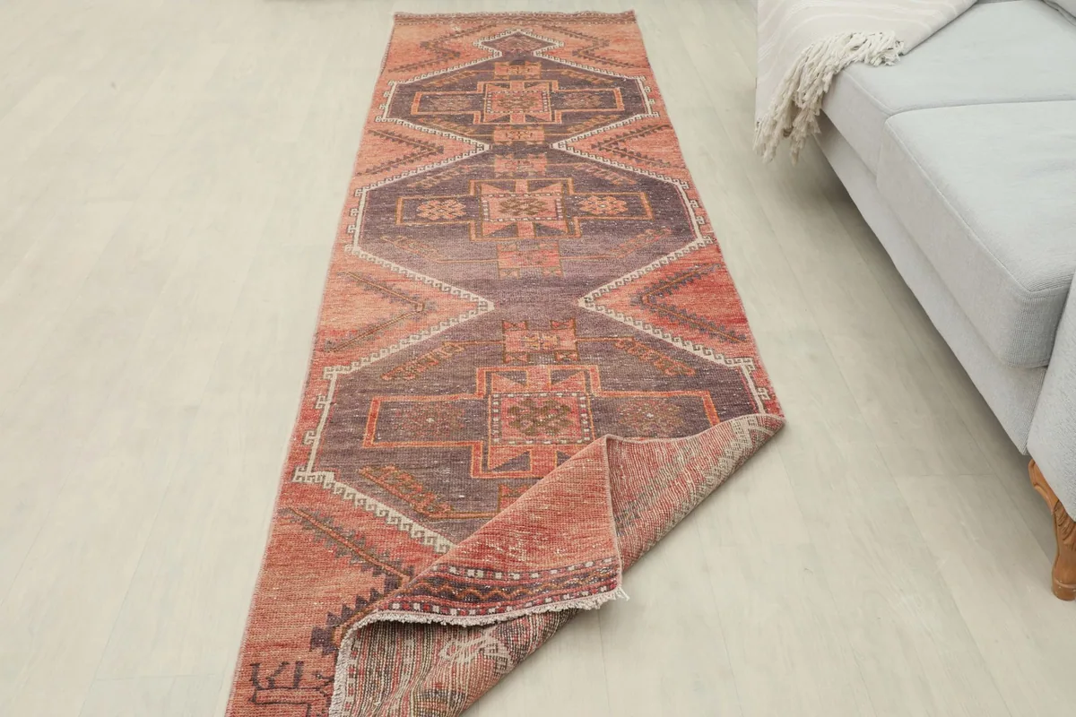 Overhead view of the runner rug partially folded, showcasing its length in a room setting.