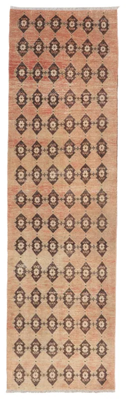 Full top view of the rust and brown geometric Anatolian runner rug on a white background