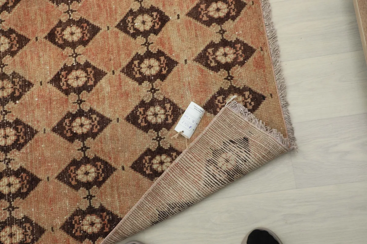 Close-up of the rug's back, showing the hand-knotted construction and foundation