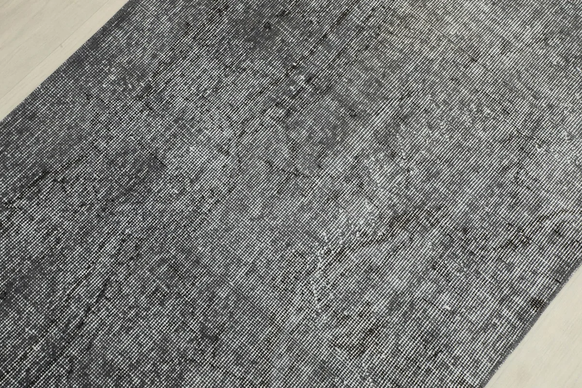 Detailed view of the rug's surface, revealing the hand-knotted wool pile and underlying patterns
